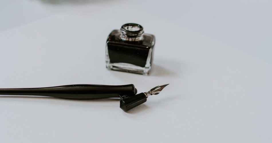 Straight pen oblique holder with a jar of black ink
